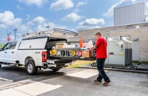 A technician easily slides the extendobed from the back of his 8' truck bed.