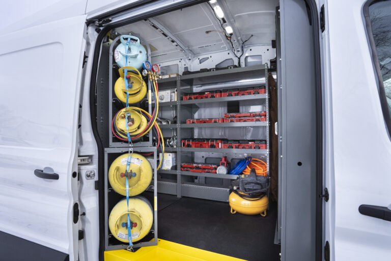 Work van with door open showing van storage racks and items stored.